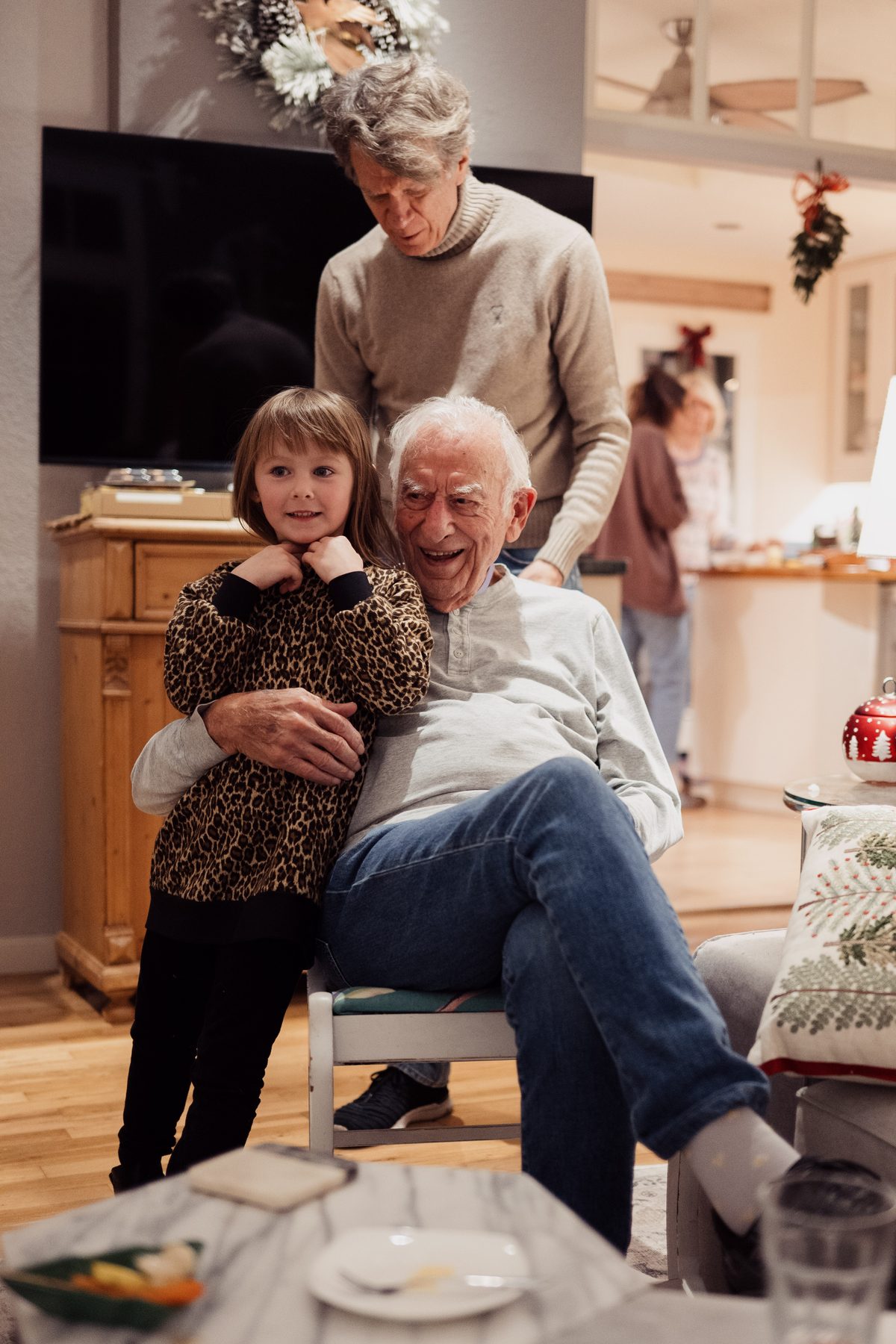 Grandpa laughing with granddaughter at Christmas